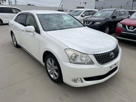 2012 Toyota Crown Majesta V8 4.6L C Type Luxury Sedan in white parked in a lot, showcasing its sleek exterior.