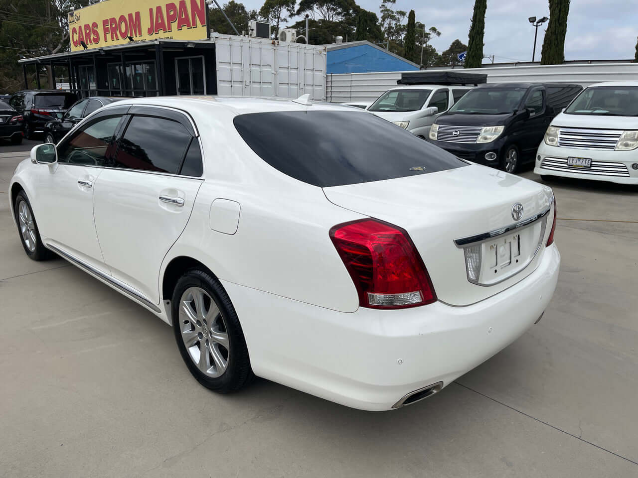2012 Toyota Crown Majesta V8 4.6L C Type Luxury Sedan in white rear view, showcasing stylish design and elegance.