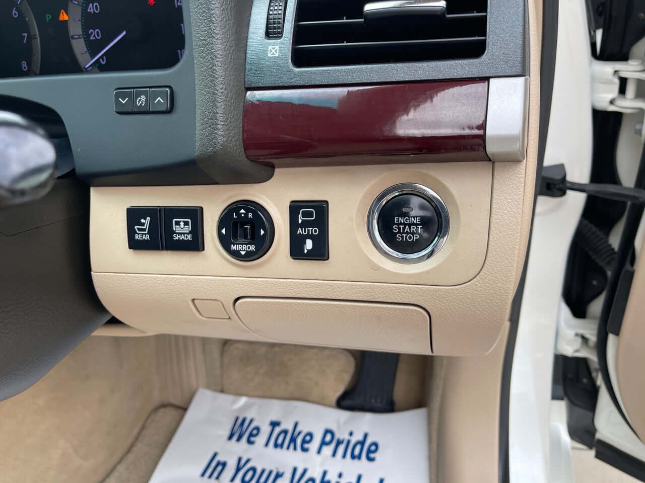 Interior controls of a 2012 Toyota Crown Majesta V8 4.6L showing engine start button and various settings.
