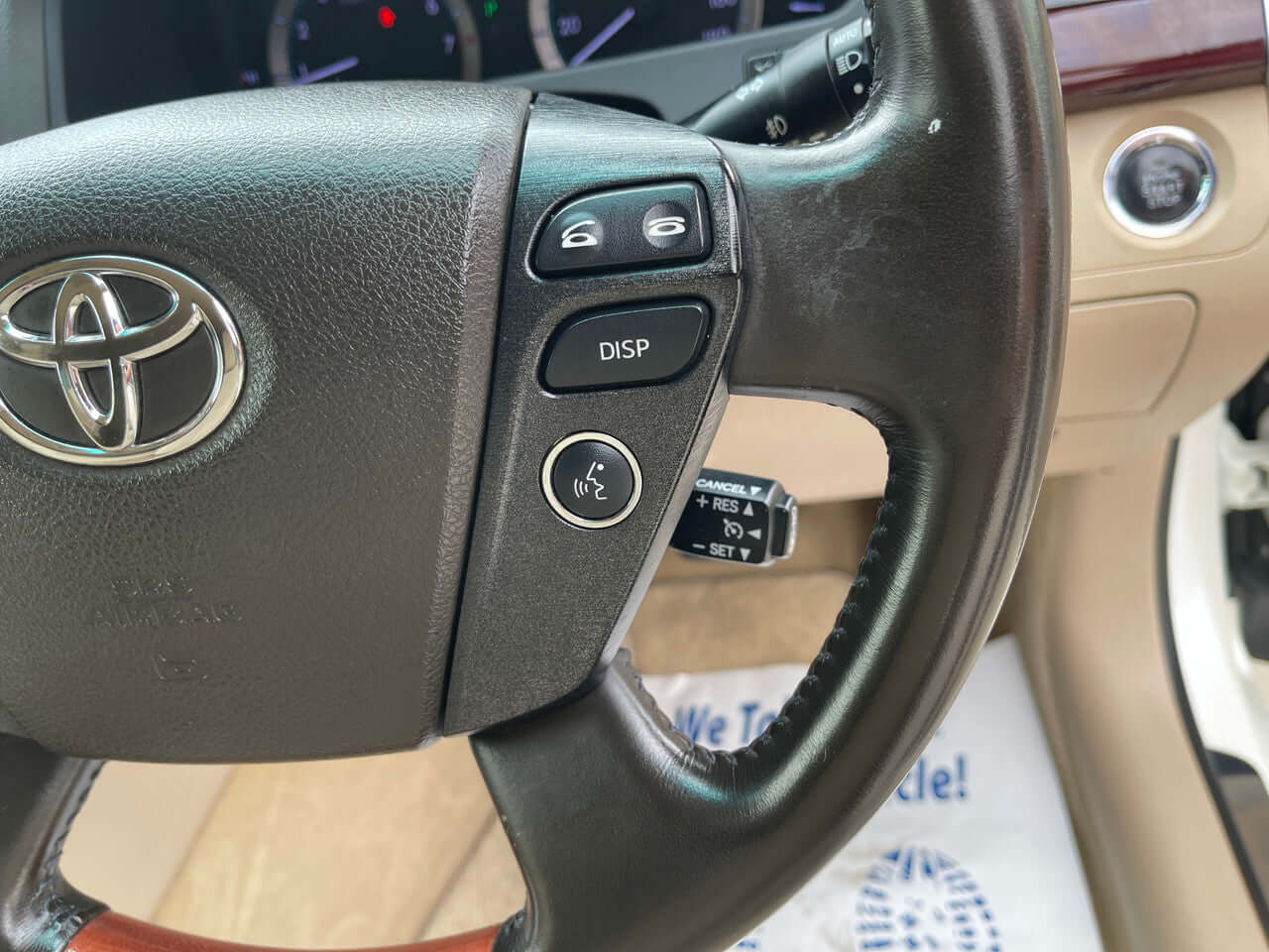 Close-up view of the steering wheel controls in a 2012 Toyota Crown Majesta V8 4.6L, featuring buttons for display and audio settings.