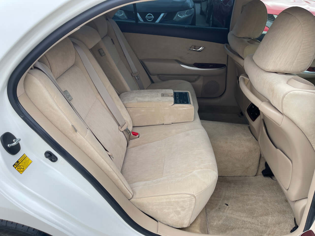 Interior view of the back seat of a 2012 Toyota Crown Majesta V8 4.6L C Type Luxury Sedan, showcasing beige upholstery and spacious seating.