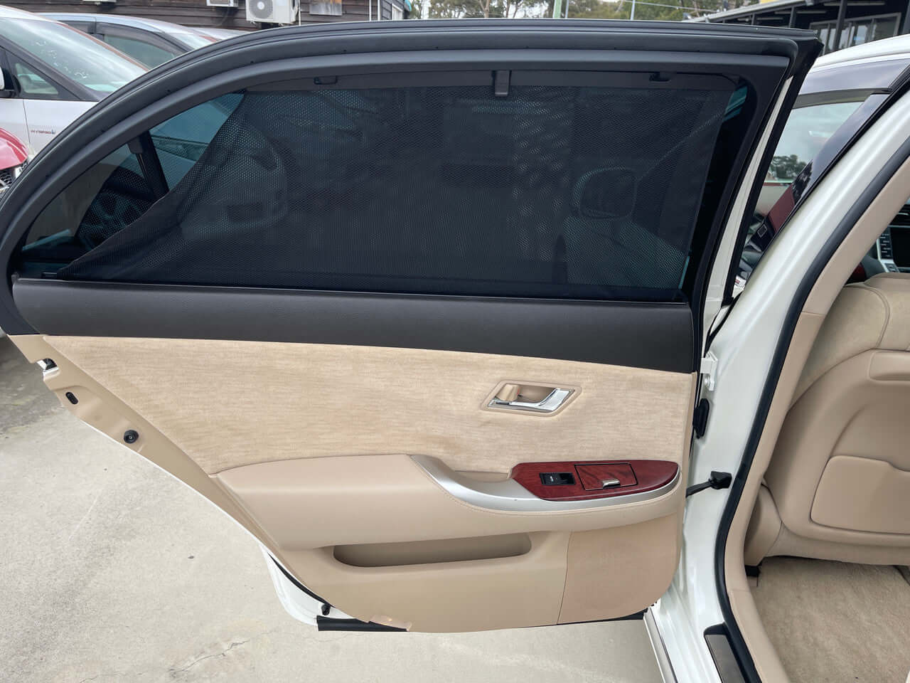 Interior of the 2012 Toyota Crown Majesta V8 4.6L showing the luxury door panel and window with tint.