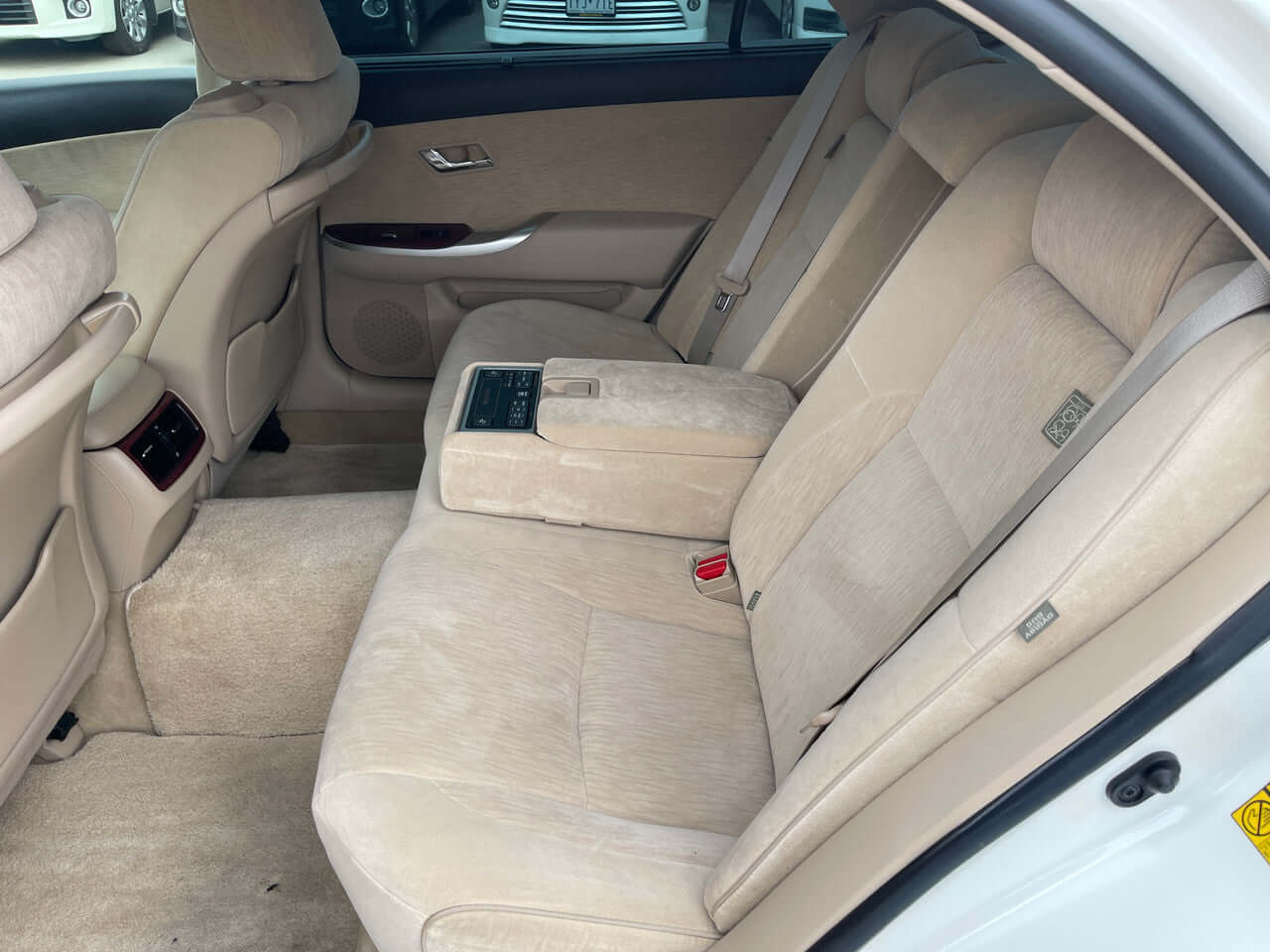 Interior view of the spacious backseat of a 2012 Toyota Crown Majesta V8 4.6L C Type Luxury Sedan.