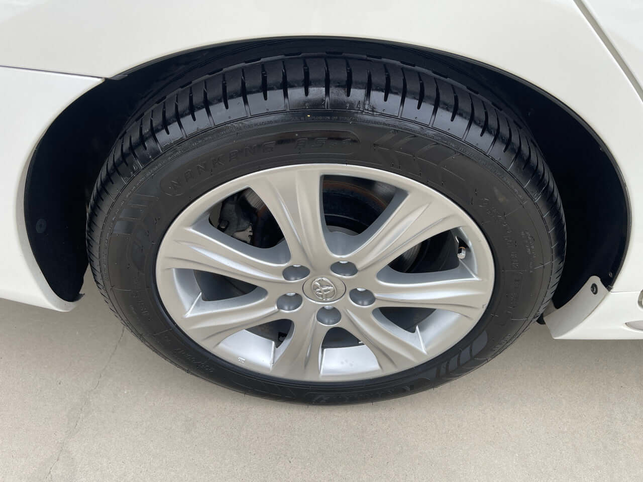 Close-up view of the wheel and tire of a 2012 Toyota Crown Majesta V8 4.6L luxury sedan.