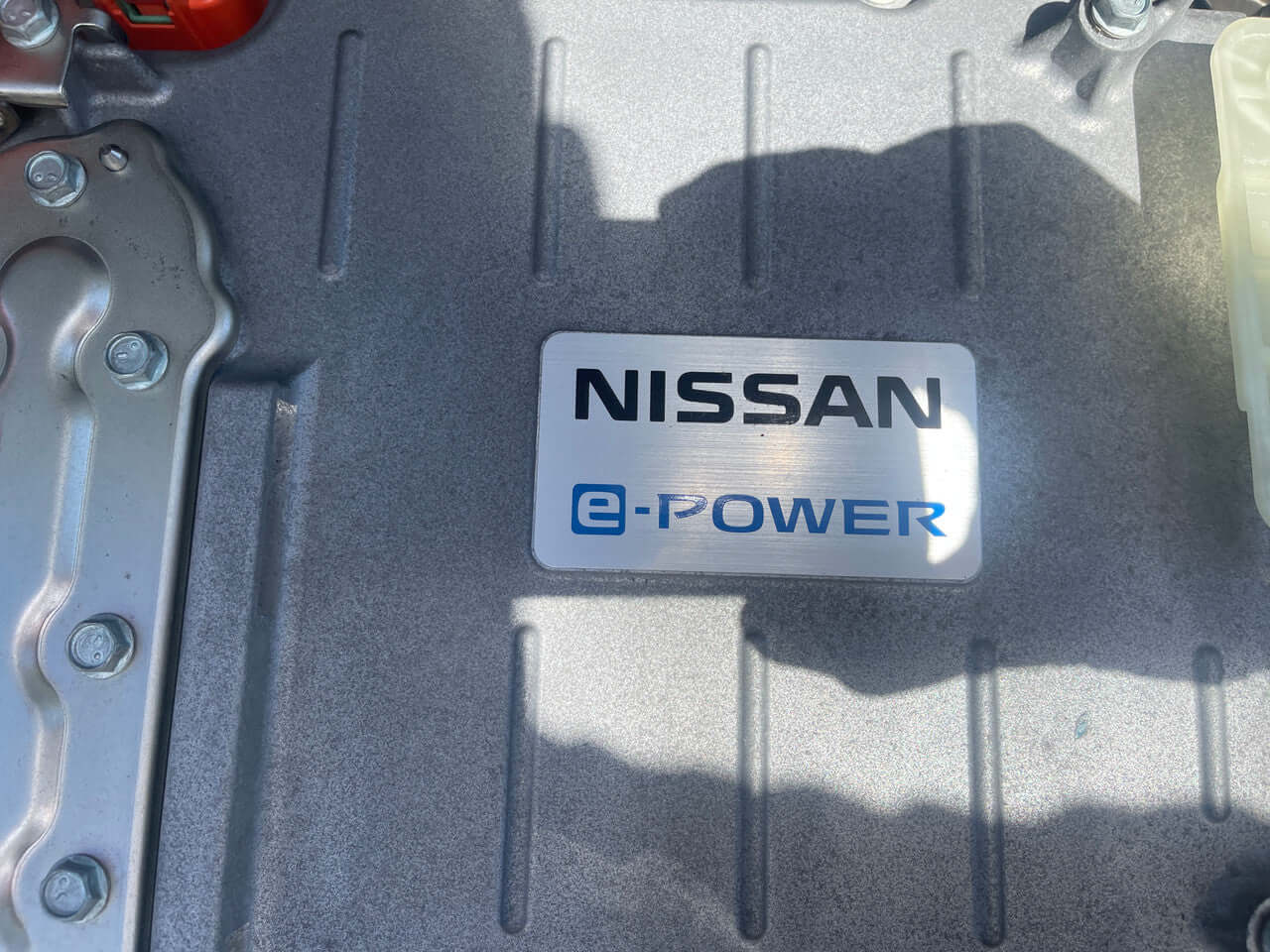 2018 Nissan Note e-Power Nismo Edition Close-up of Nissan e-Power badge on engine component, emphasizing electric hybrid technology.