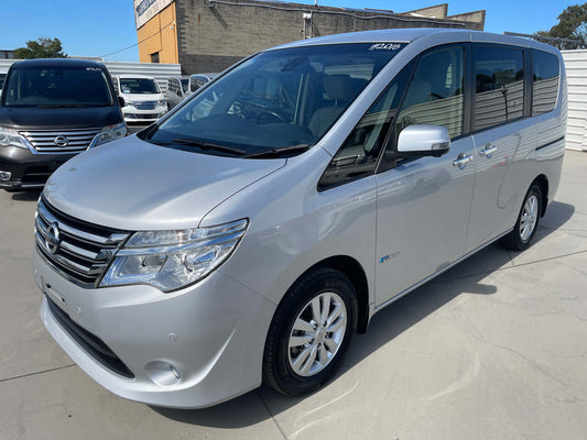 2015 Nissan Serena 2.0L S-Hybrid parked in a lot, showcasing its sleek silver exterior and spacious design.