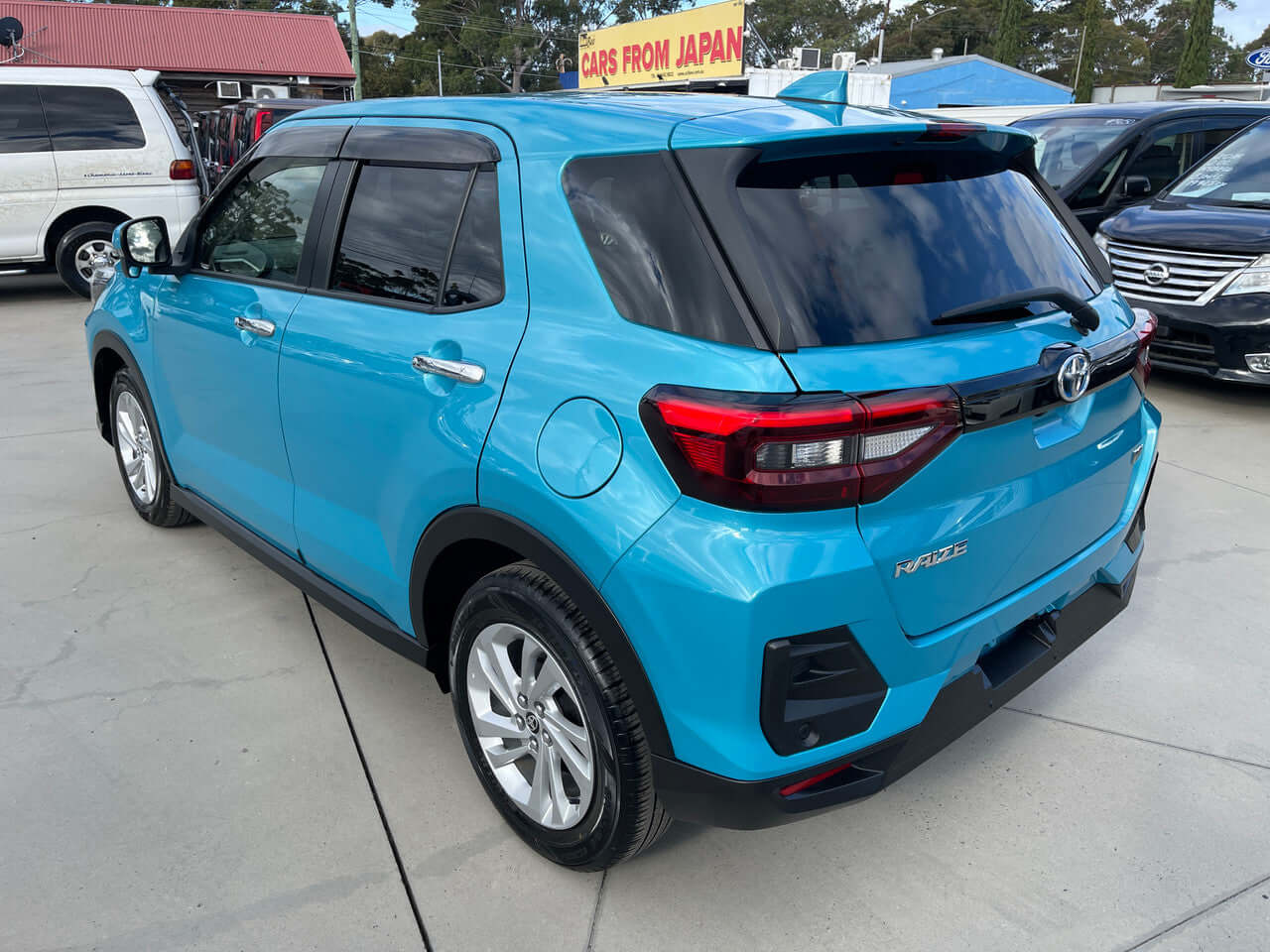 2022 Toyota Raize 1.2L e-Smart Hybrid G compact SUV in blue color parked, showcasing rear view and design features.