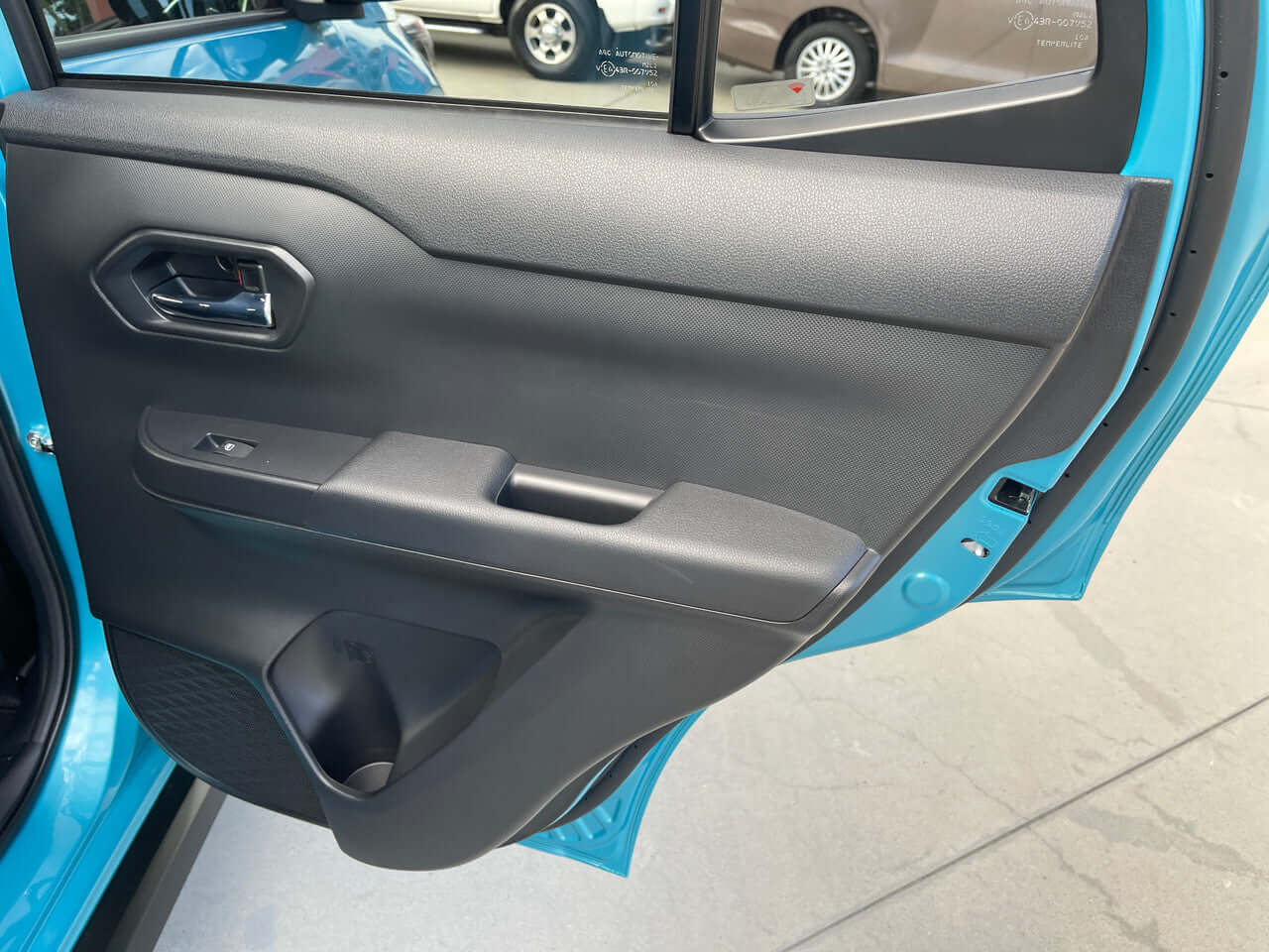 Interior door panel of the 2022 Toyota Raize 1.2L e-Smart Hybrid G, showcasing modern design features.