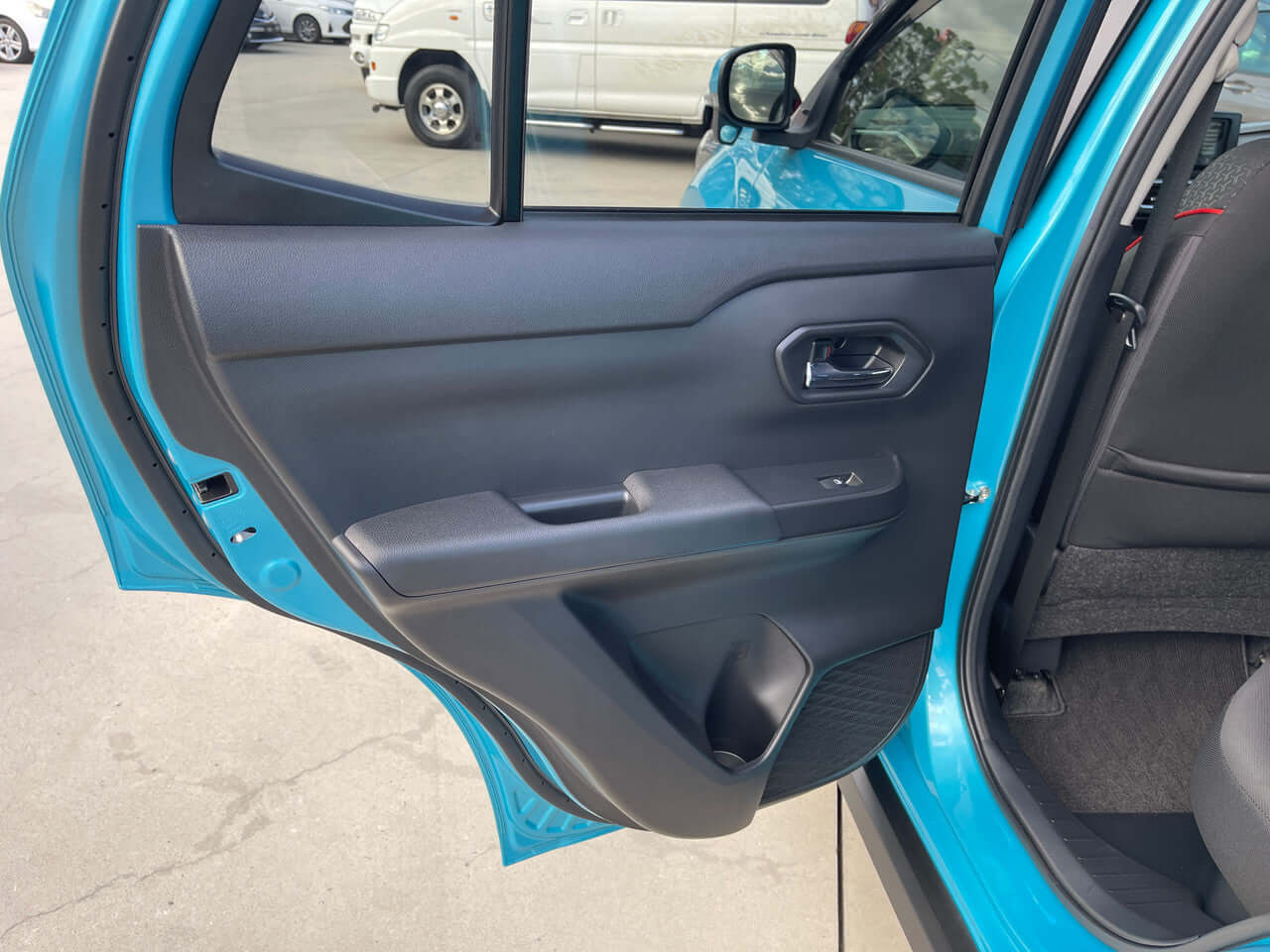 Interior door panel of the 2022 Toyota Raize 1.2L e-Smart Hybrid G compact SUV in blue color.