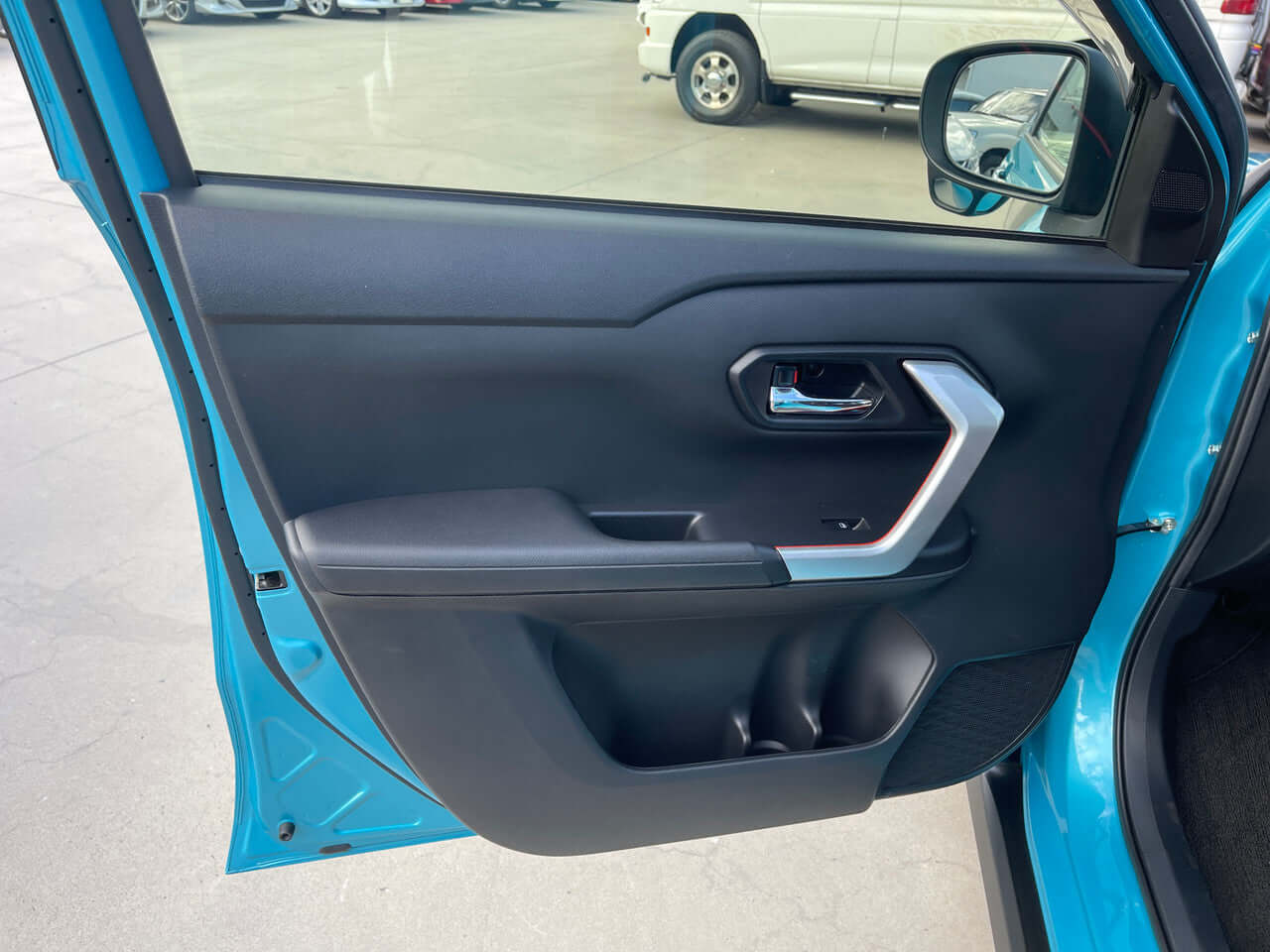 Interior door panel of a 2022 Toyota Raize 1.2L e-Smart Hybrid G, showcasing modern design and ergonomic features.