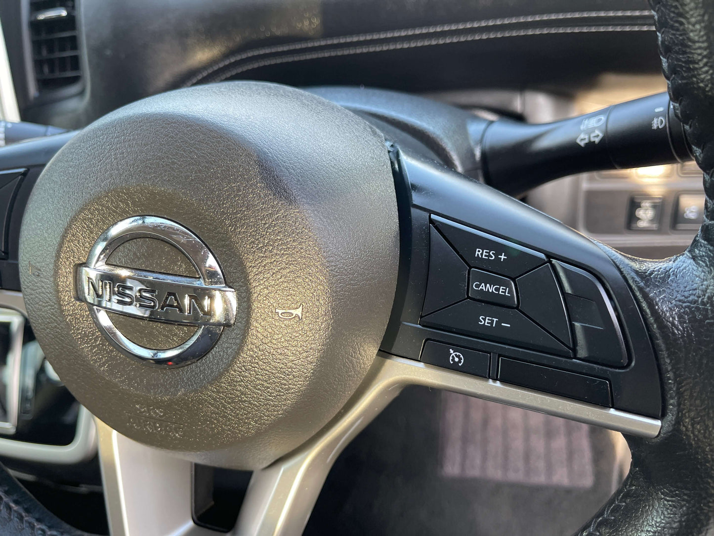 2017 Nissan Serena 2.0L S-Hybrid steering wheel with control buttons, showcasing the Nissan logo.