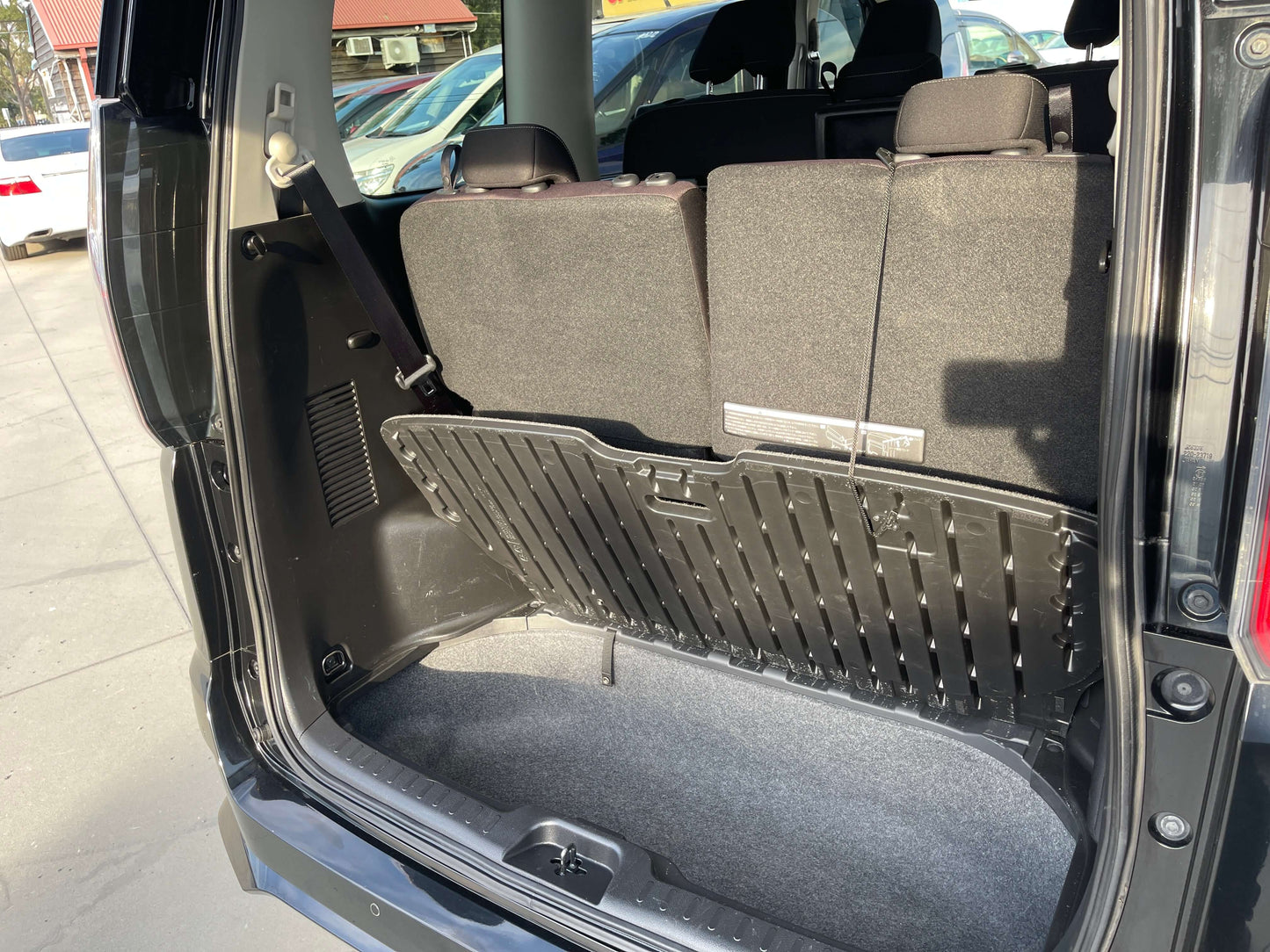 Interior view of the cargo space in a 2017 Nissan Serena 2.0L S-Hybrid, showcasing foldable seats.
