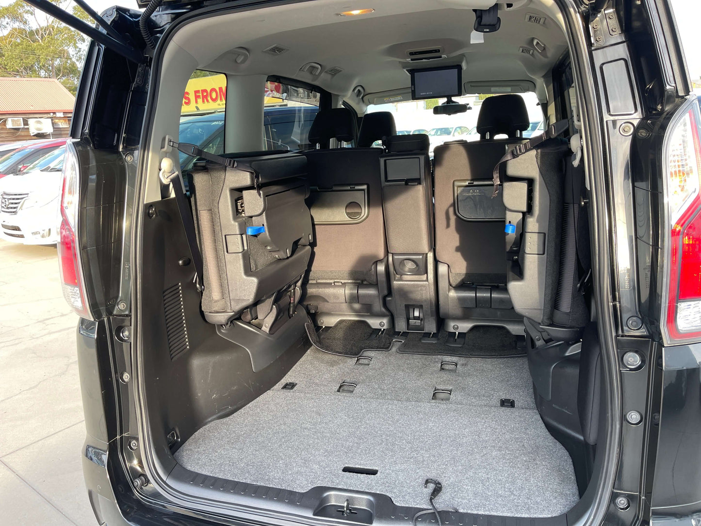 Interior cargo space of 2017 Nissan Serena 2.0L S-Hybrid with back seats folded down for spacious storage.