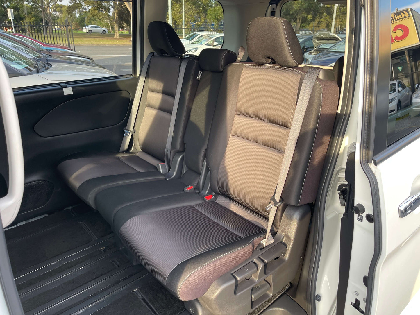 Interior view of the back seat in a 2016 Nissan Serena 2.0L S-Hybrid, featuring 8 seats and modern upholstery.