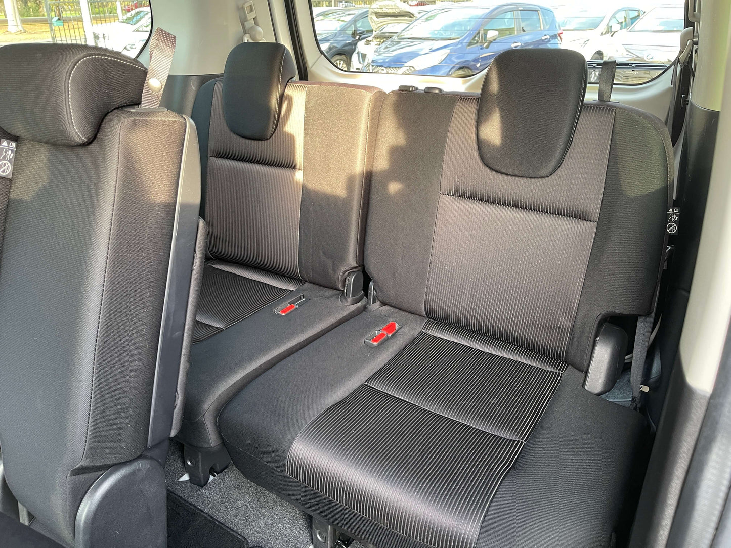 Interior view of the rear seating area in a 2016 Nissan Serena 2.0L S-Hybrid, showcasing 8 seats.