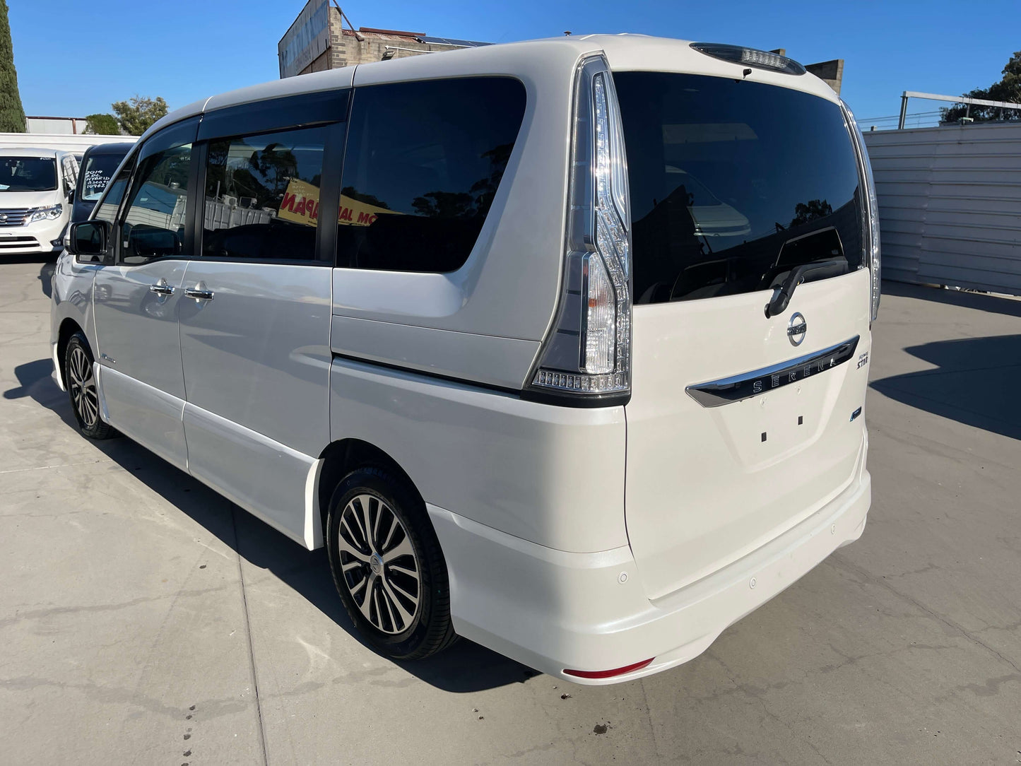 2015 Nissan Serena 2.0L S-Hybrid Highway Star rear view in white, 8-seater MPV with stylish design, showcasing modern features.