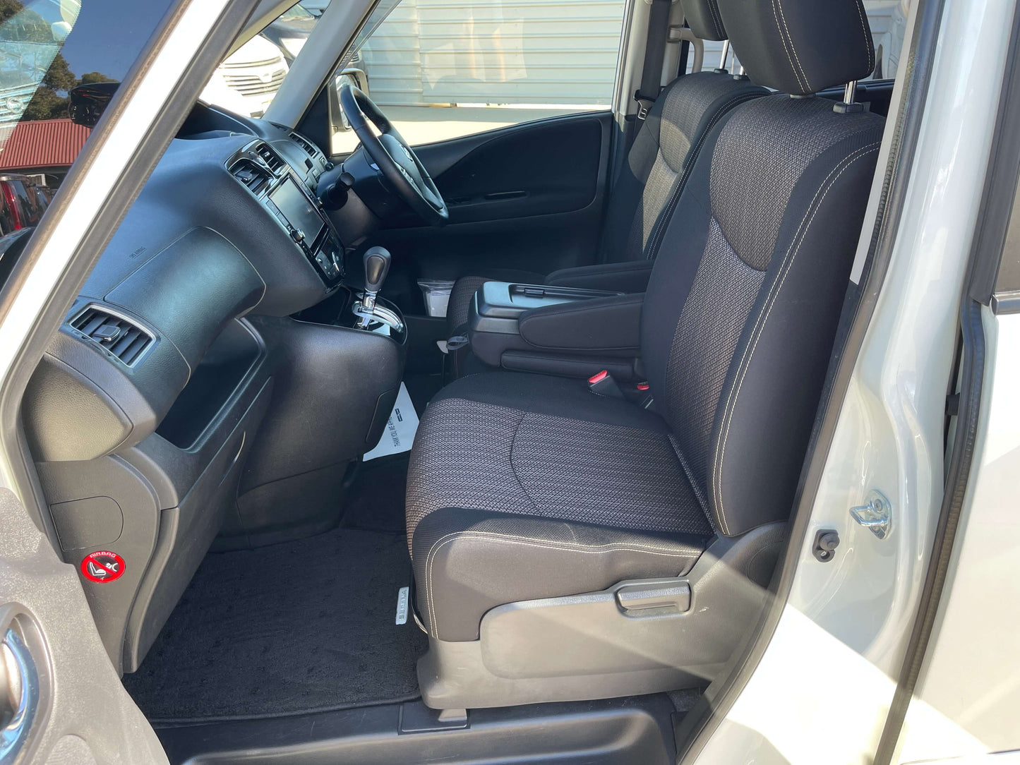 Interior view of 2015 Nissan Serena 2.0L S-Hybrid with front seats and dashboard.