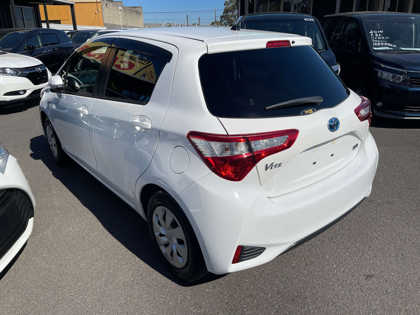 2020 Toyota Vitz 1.5L Hybrid F Safety Edition, rear view of the white hatchback with distinctive taillights.