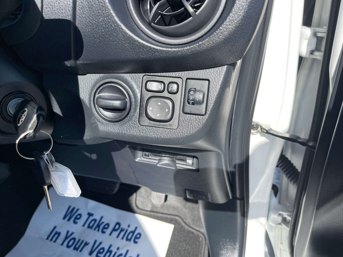 Interior controls view of the 2020 Toyota Vitz 1.5L Hybrid F Safety Edition, featuring air vent and switches.