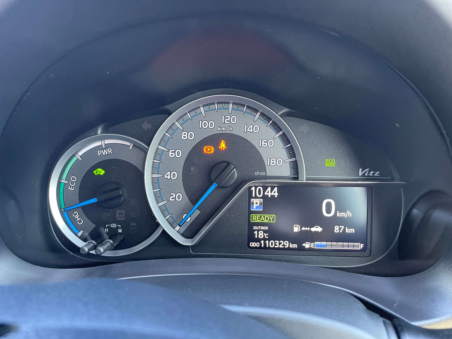 2020 Toyota Vitz 1.5L Hybrid dashboard display showing speed, fuel, and mileage of 110329 km.