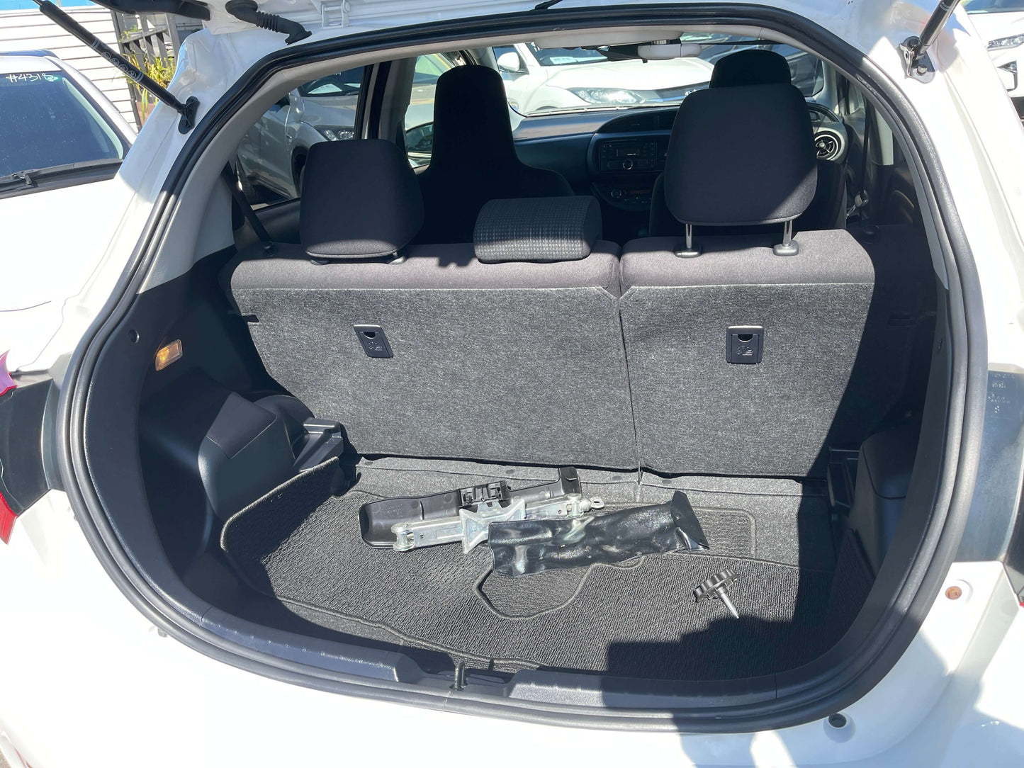 Interior view of the rear storage space in a 2020 Toyota Vitz 1.5L Hybrid F Safety Edition.