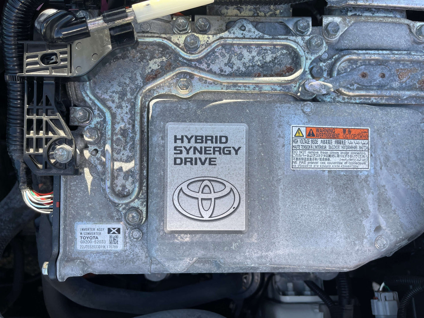 2020 Toyota Vitz 1.5L Hybrid engine showing Hybrid Synergy Drive system components and branding.