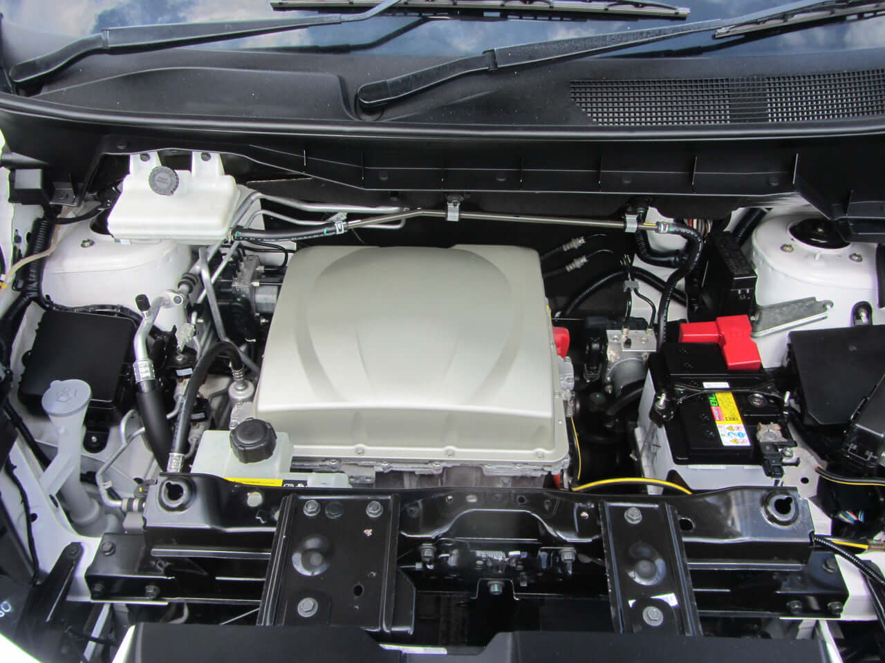 Engine compartment of 2015 Nissan e-NV200 24kW Full Electric, showcasing the electric powertrain features.