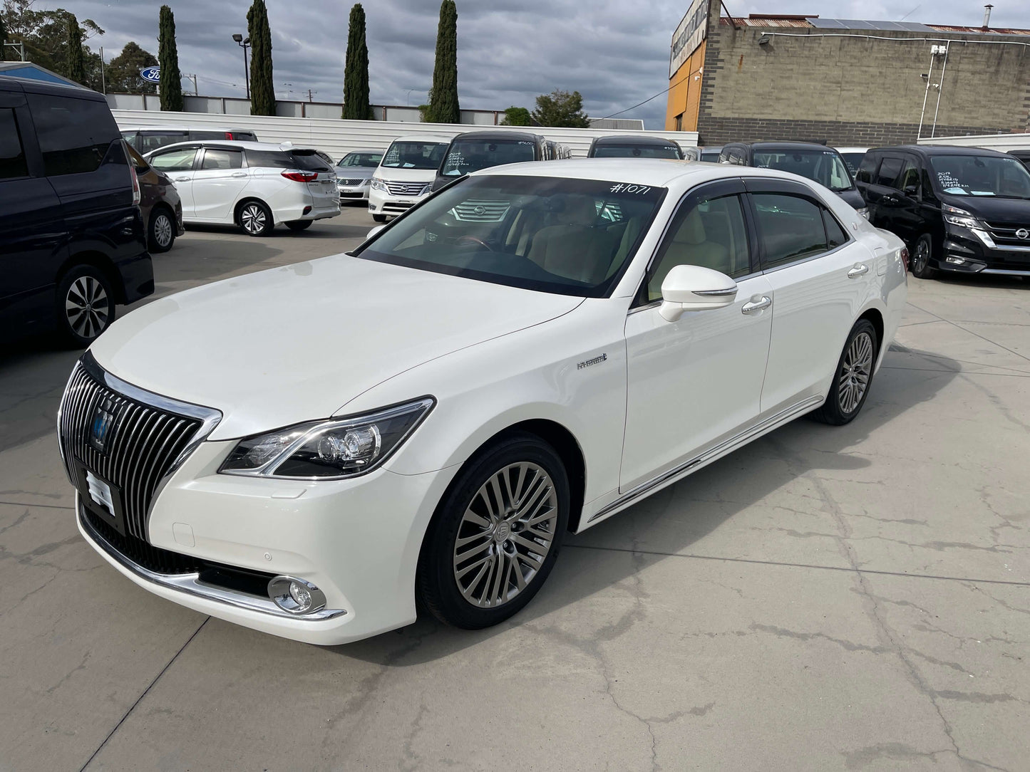 2014 Toyota Crown Majesta V6 3.5L Hybrid Luxury Sedan in white parked with other vehicles.