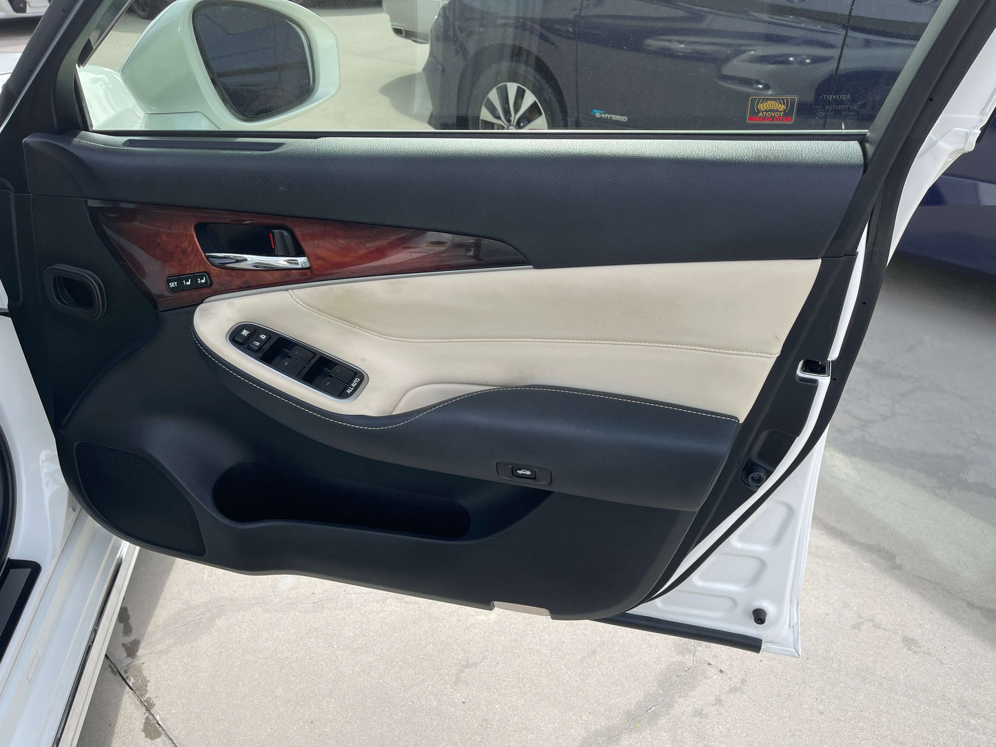 Interior view of a 2014 Toyota Crown Majesta V6 3.5L Hybrid luxury sedan door with wood and leather accents.