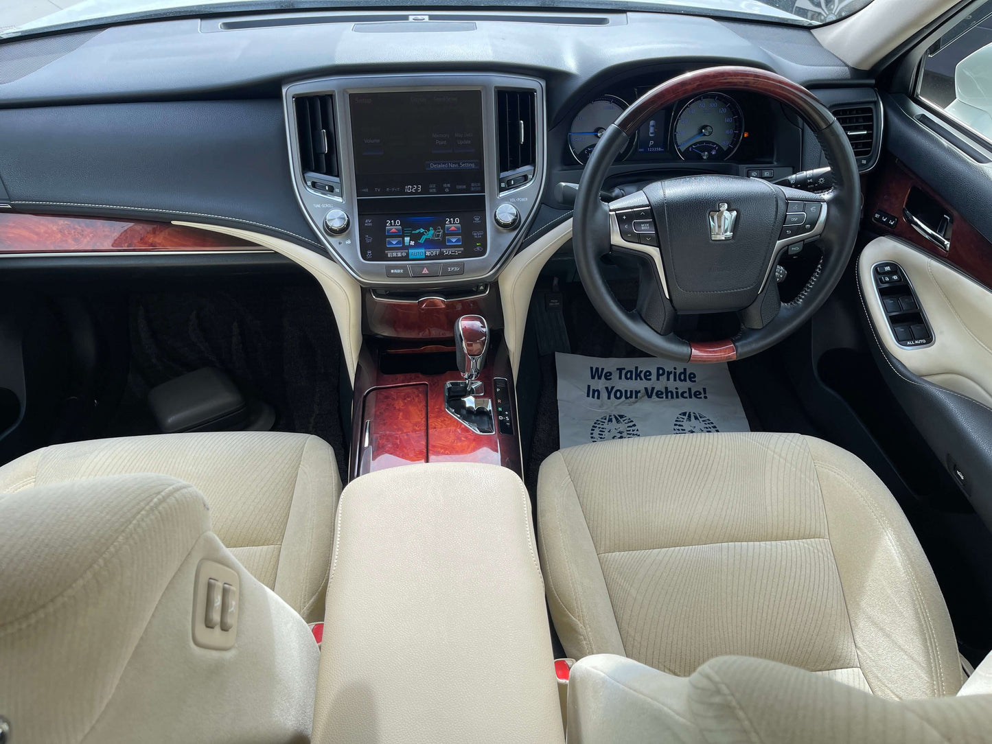 Interior view of a 2014 Toyota Crown Majesta V6 3.5L Hybrid Luxury Sedan showcasing dashboard and seating.
