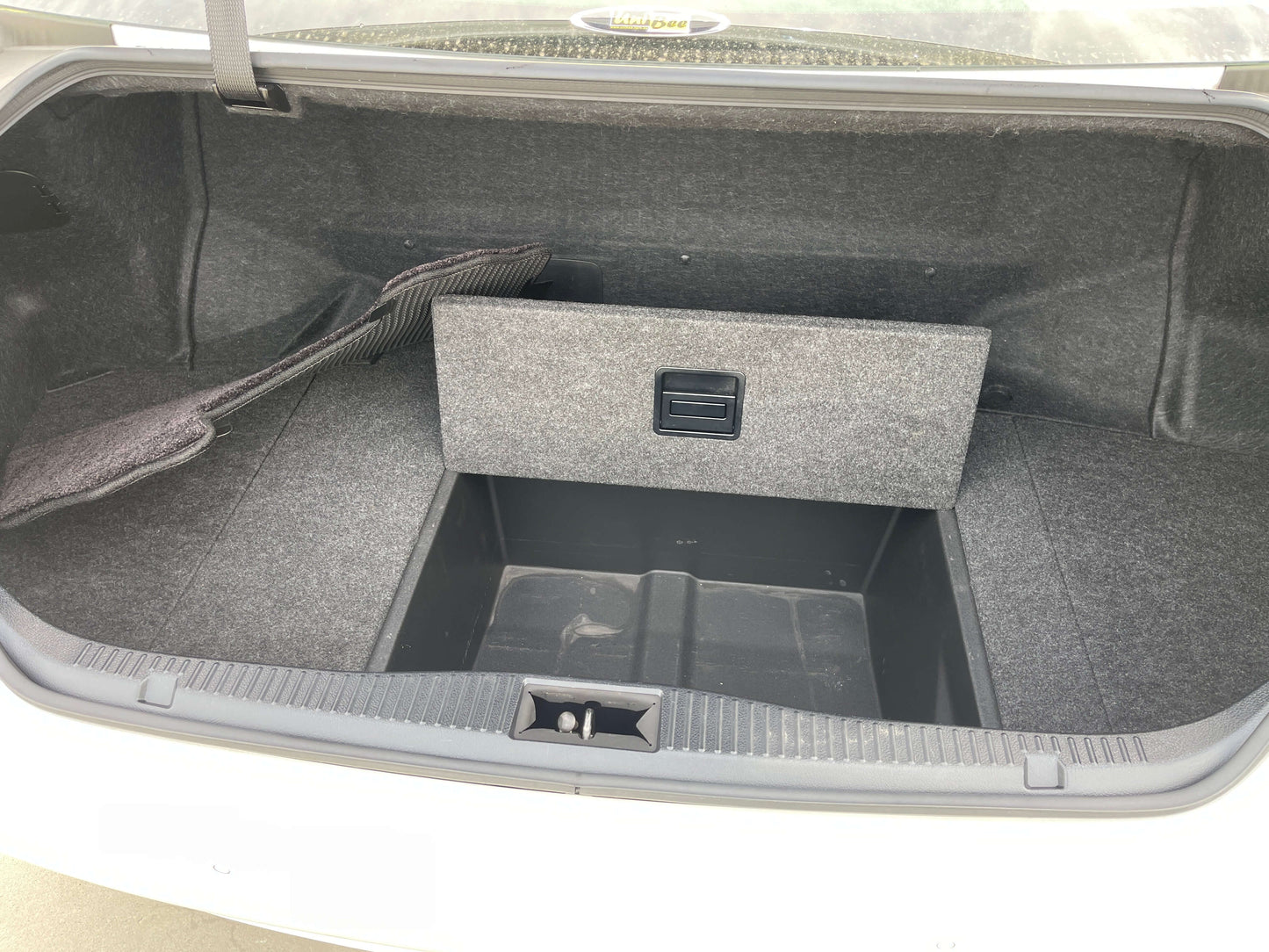 Trunk space of 2014 Toyota Crown Majesta V6 3.5L Hybrid Luxury Sedan, featuring storage compartment and carpet lining.