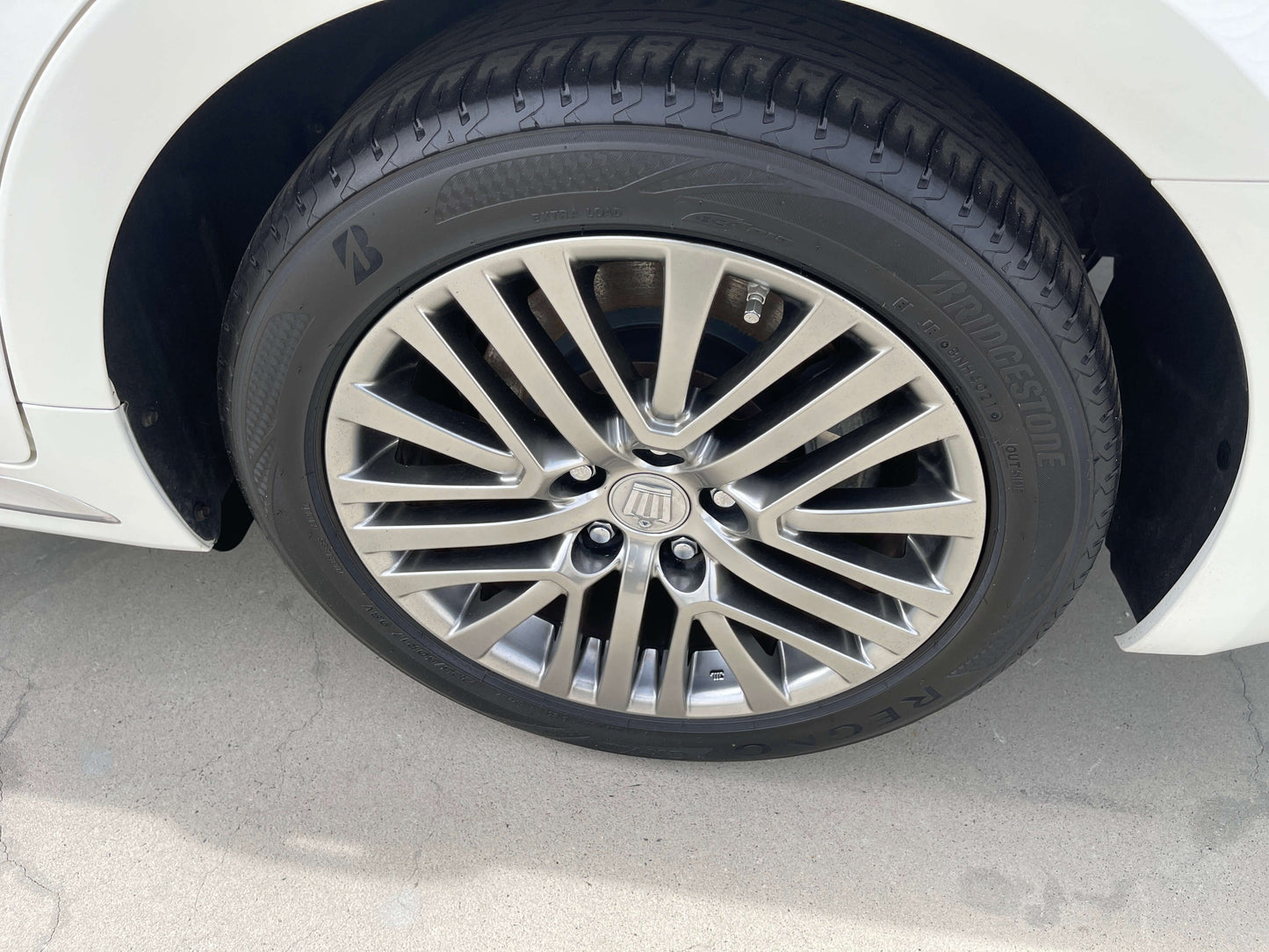 Close-up of a stylish alloy wheel on a 2014 Toyota Crown Majesta V6 3.5L Hybrid Luxury Sedan.