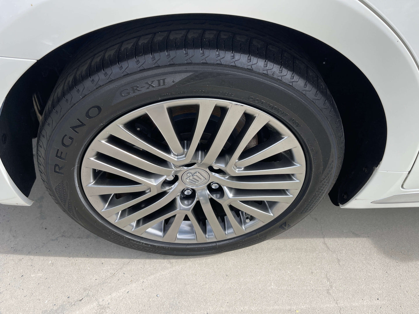 Close-up of the alloy wheel and tire of a 2014 Toyota Crown Majesta V6 3.5L Hybrid luxury sedan.