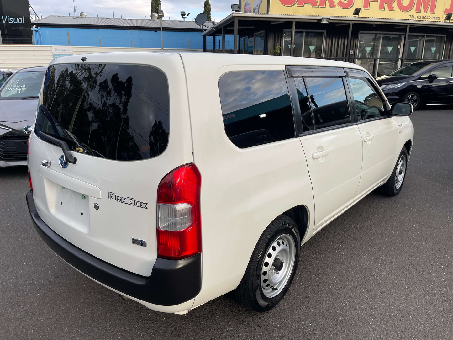 2020 Toyota Probox Hybrid 1.5L Station Wagon rear view in white, showcasing its sleek design and spacious layout.