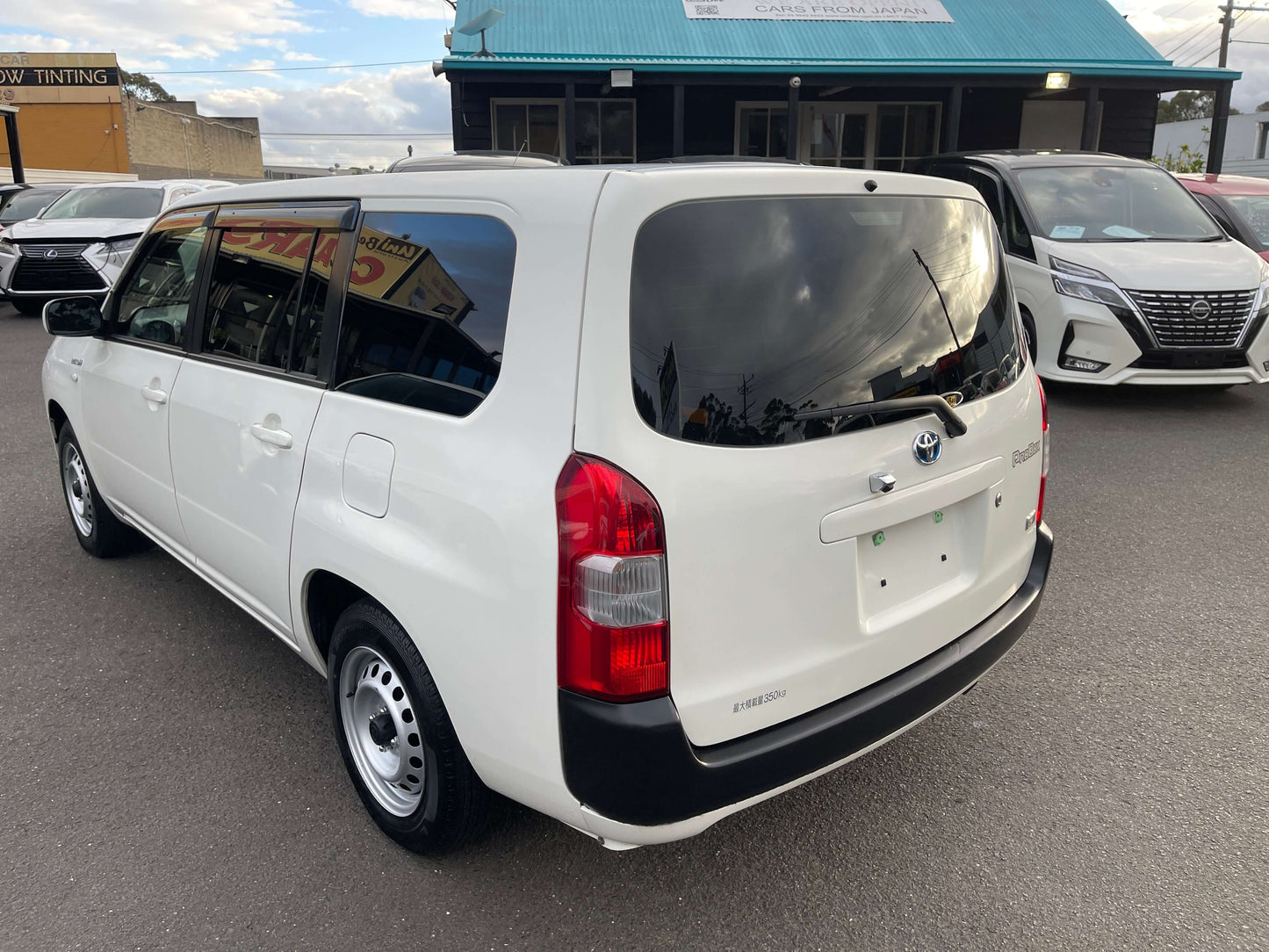 2020 Toyota Probox Hybrid 1.5L Station Wagon rear view, showcasing white exterior, license plate area, and tinted windows.