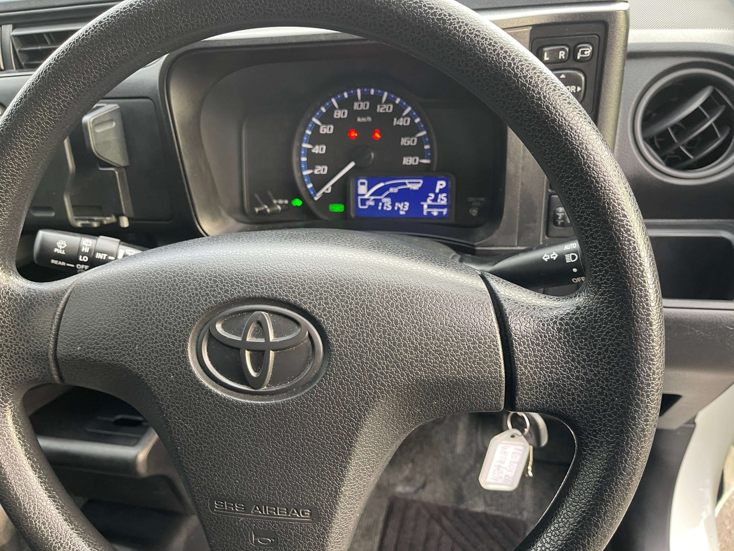 Interior view of 2020 Toyota Probox Hybrid 1.5L Station Wagon dashboard and steering wheel.