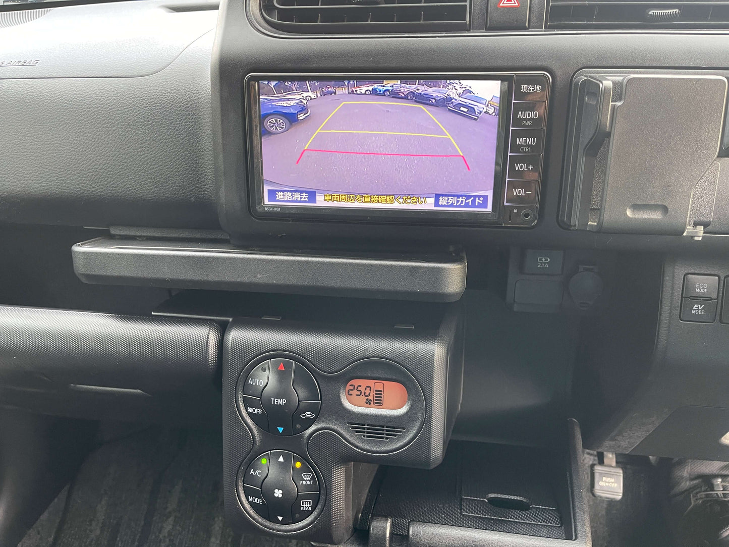 Interior view of 2020 Toyota Probox Hybrid 1.5L station wagon showing dashboard controls and rearview camera display.