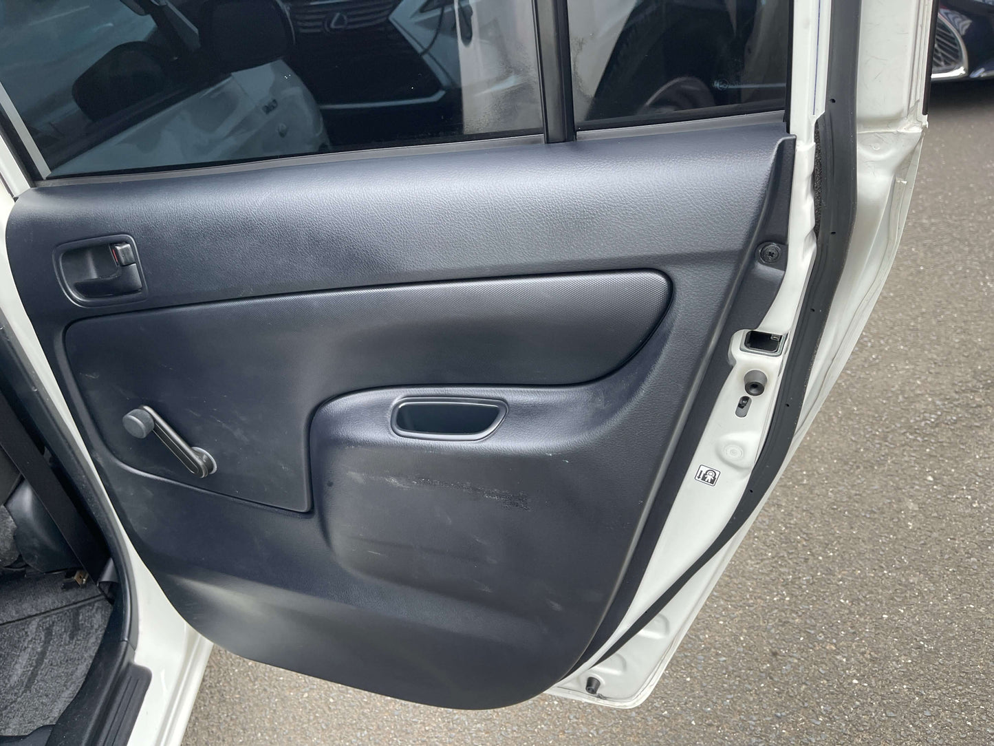 Interior door panel of 2020 Toyota Probox Hybrid 1.5L Station Wagon showing door handle and window controls.