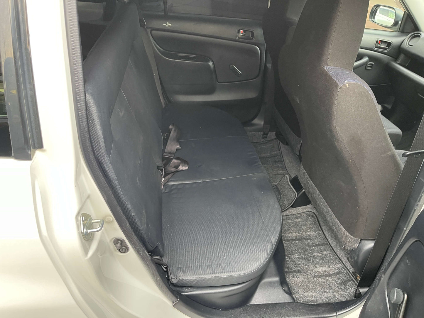 Interior view of the rear seating area of a 2020 Toyota Probox Hybrid 1.5L Station Wagon.