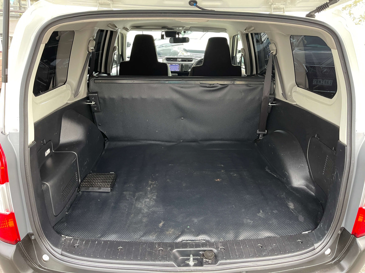 Interior view of the cargo space of a 2020 Toyota Probox Hybrid 1.5L Station Wagon.