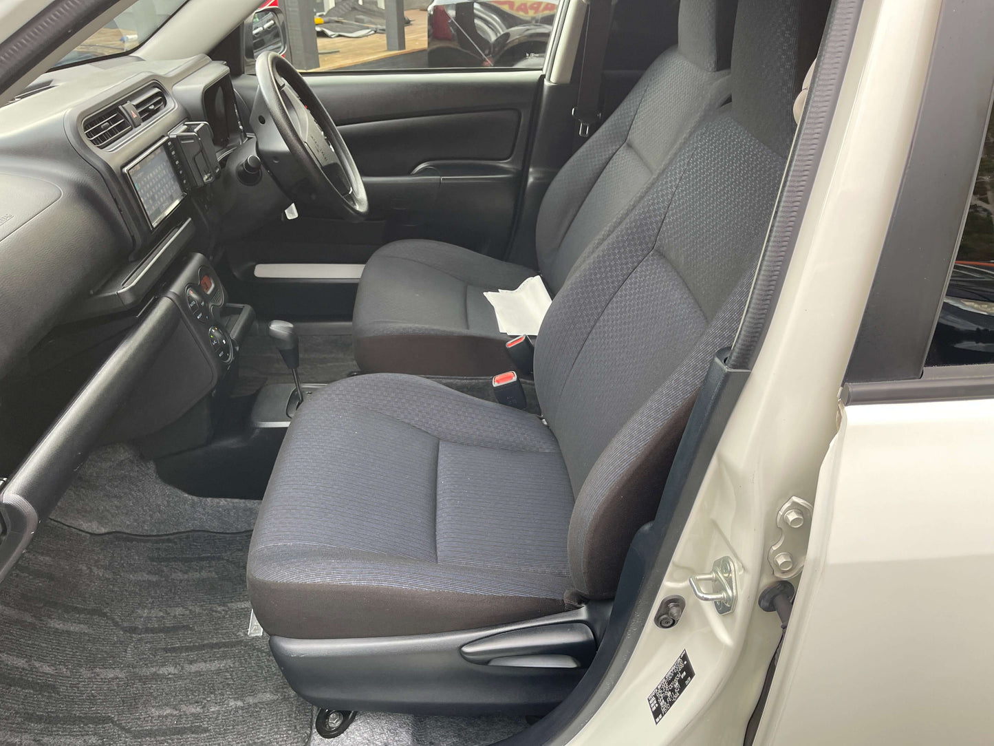 Interior view of 2020 Toyota Probox Hybrid 1.5L Station Wagon showing front seats and dashboard.