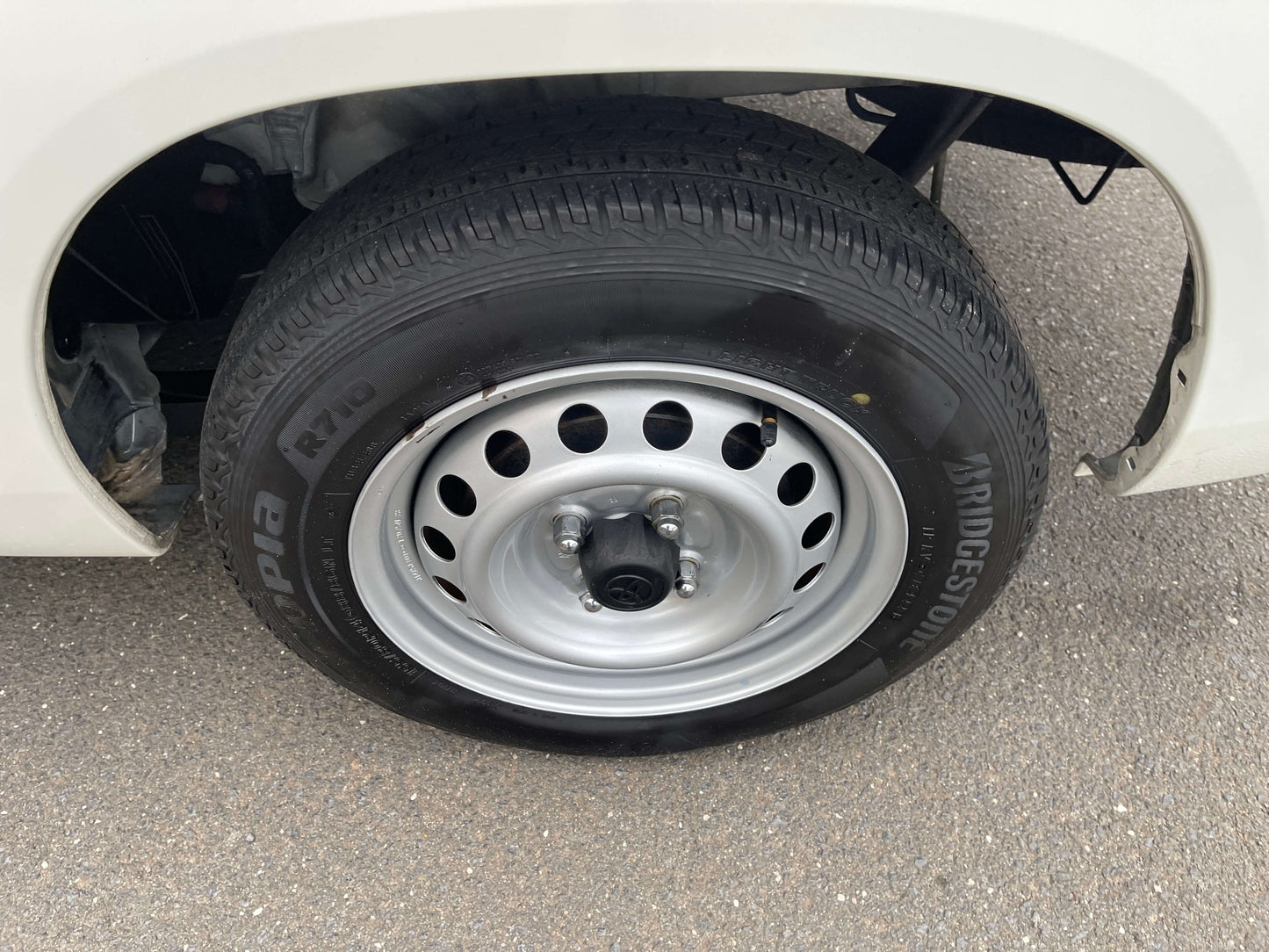 Close-up view of a 2020 Toyota Probox Hybrid 1.5L Station Wagon wheel and Bridgestone tire.