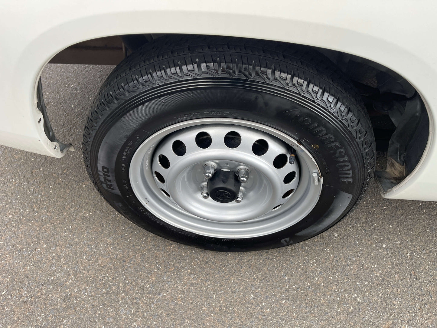 2020 Toyota Probox Hybrid 1.5L Station Wagon wheel with Bridgestone tire, showcasing tire design and rim structure.