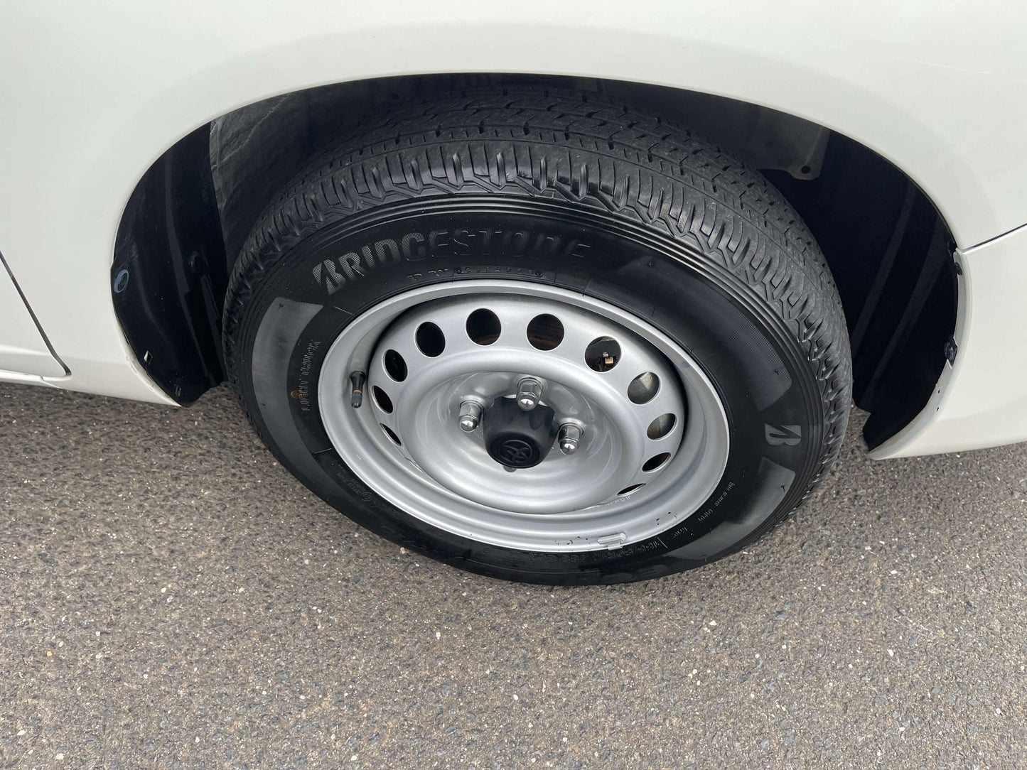 2020 Toyota Probox Hybrid 1.5L spare tire on the side of the vehicle showcasing Bridgestone design.