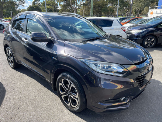 2014 Honda Vezel HR-V Hybrid Z SUV 5 seater parked, showcasing its sleek design and modern features.