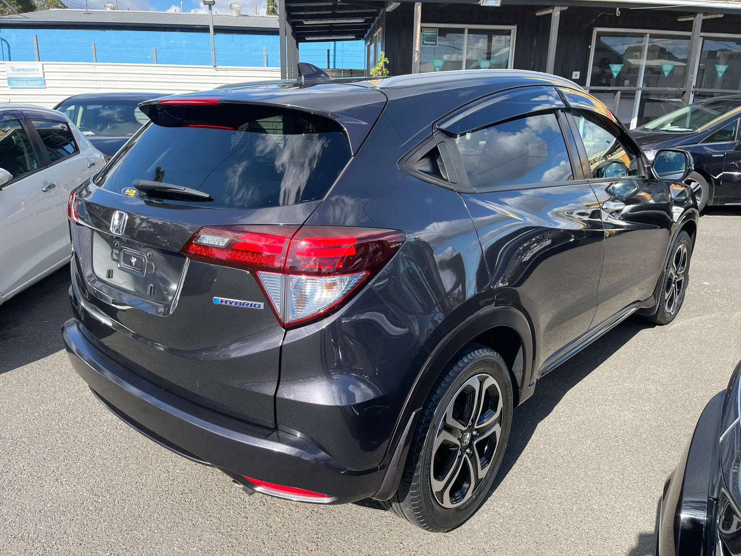 2014 Honda Vezel HR-V Hybrid Z SUV 5 seater with a sleek design parked in a dealership lot.