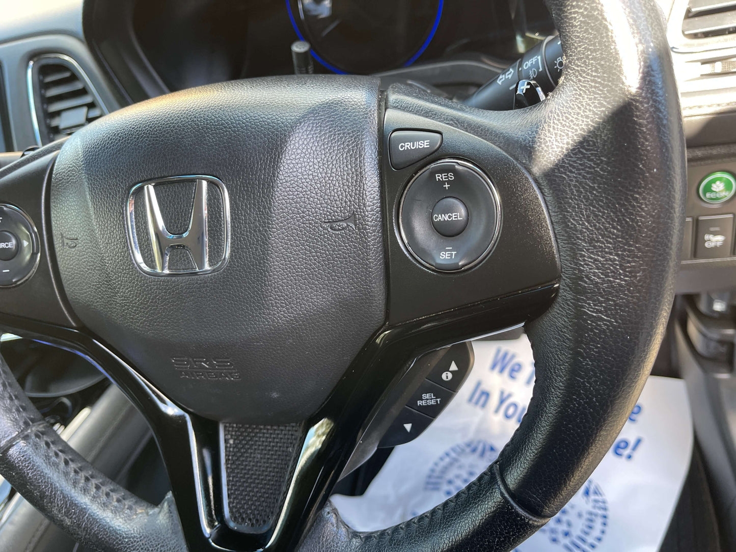 Close-up of the steering wheel features in a 2014 Honda Vezel HR-V Hybrid, showcasing cruise control buttons.