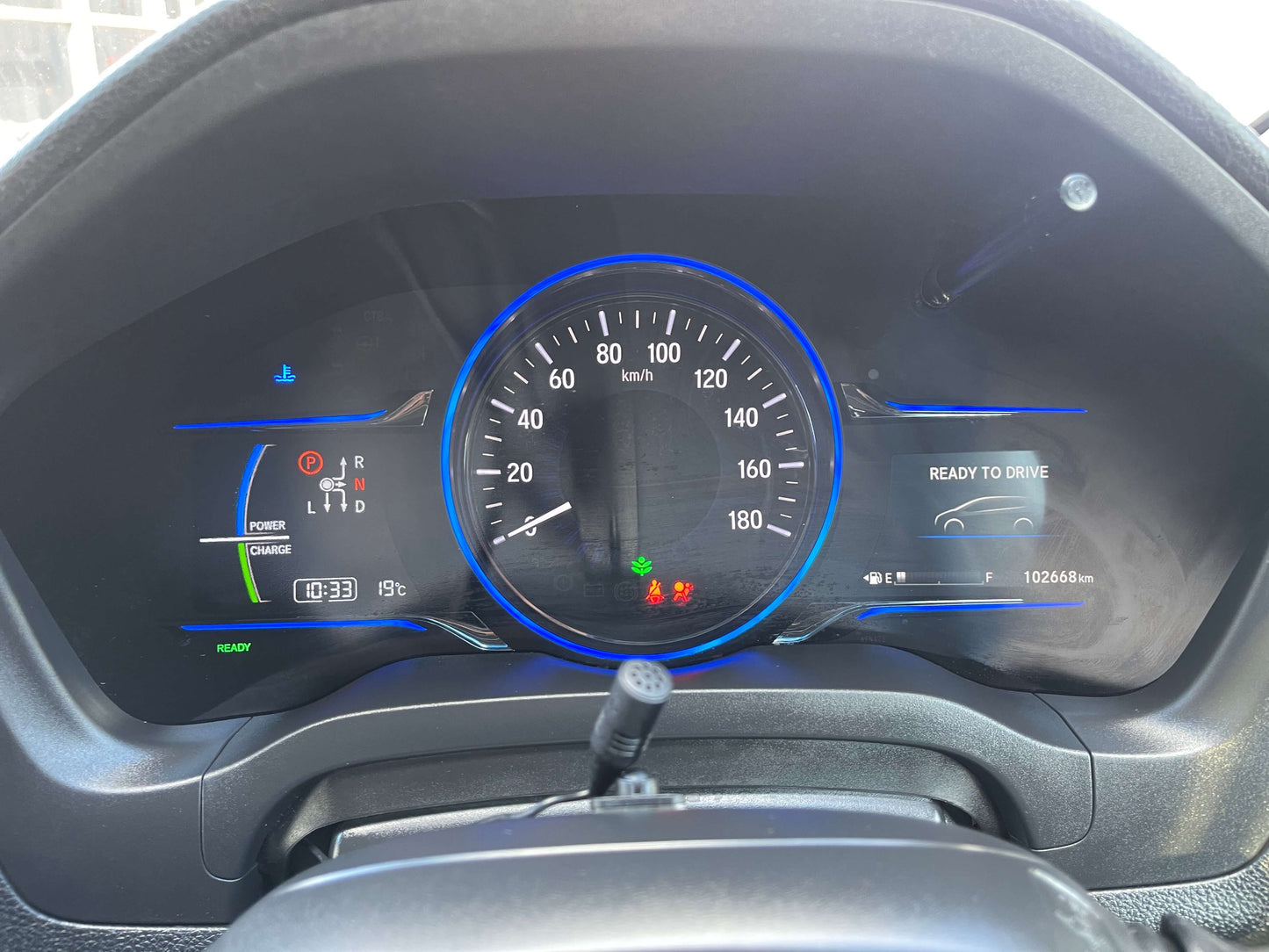 Dashboard display of a 2014 Honda Vezel HR-V Hybrid showing speedometer, charge indicators, and readiness for drive.
