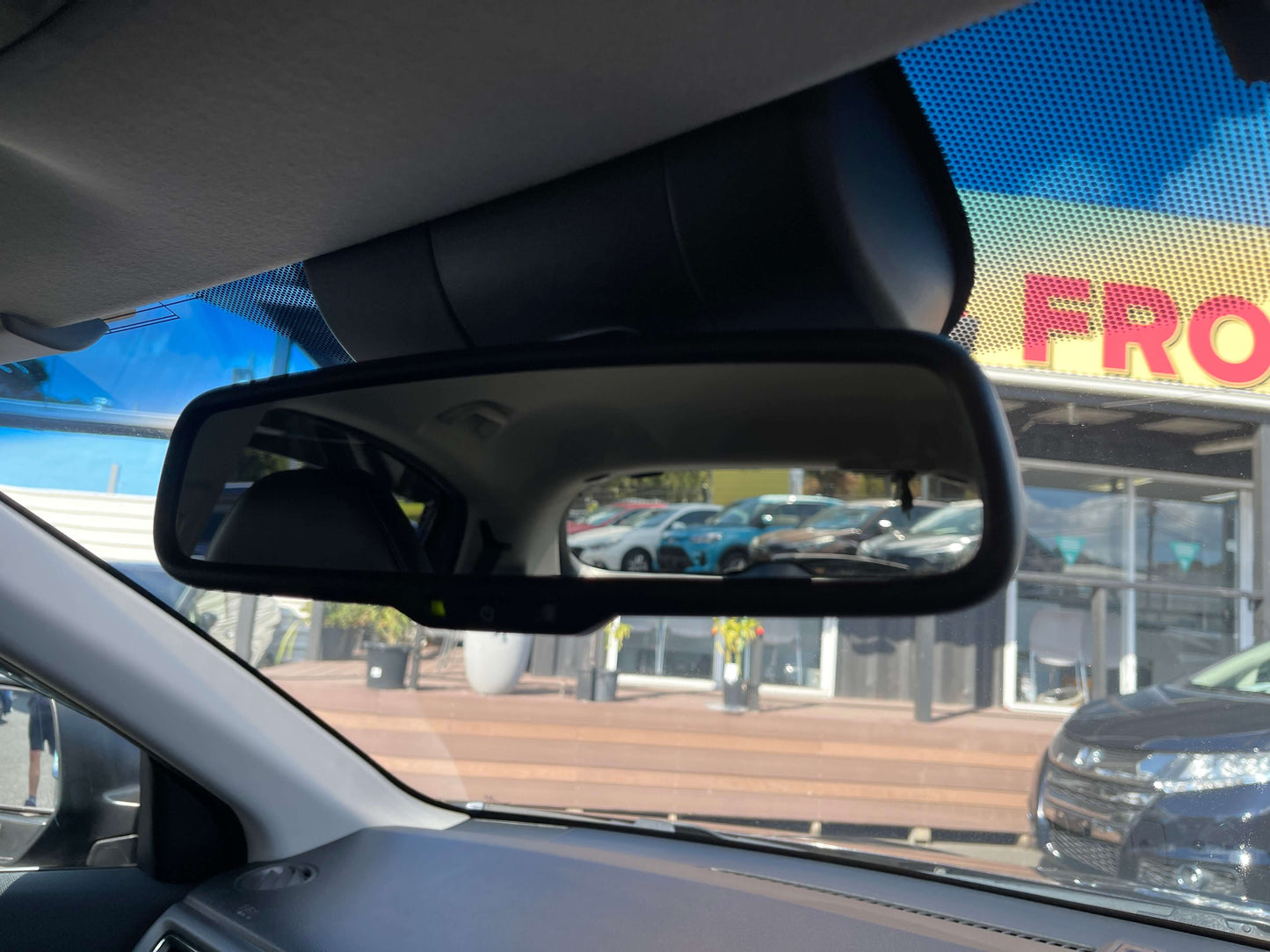 2014 Honda Vezel HR-V Hybrid Rearview mirror of a car showing the reflection of vehicles outside, showcasing a clear view inside the vehicle.