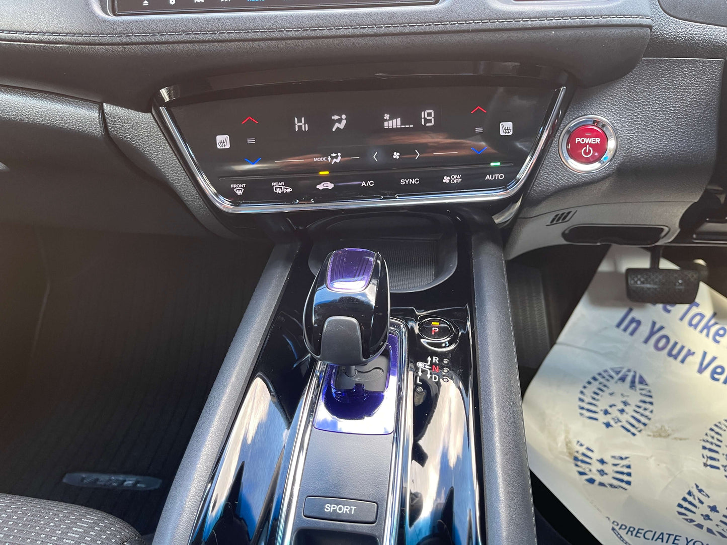 Interior view of 2014 Honda Vezel HR-V Hybrid gear shift and dashboard controls.
